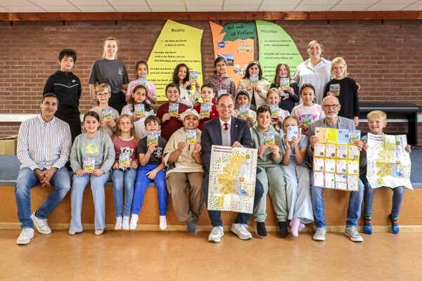 Die Sch&uuml;lerinnen und Sch&uuml;ler der Klasse 3e halten den Kinderstadtplan in den H&auml;nden.